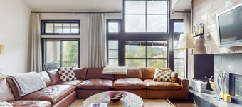 Modern retreat with wood-burning fireplace, hot tub access, and grill