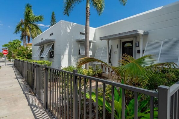 Stylish single-story residence with a front entrance and lush greenery surroundings.