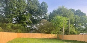 Enjoy a serene escape in a secluded wooded setting with a lush grassy lawn.