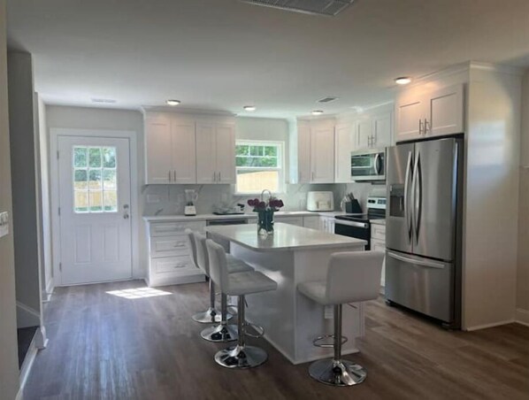 Enjoy cooking in this well-equipped kitchen with a central island and stainless steel appliances.