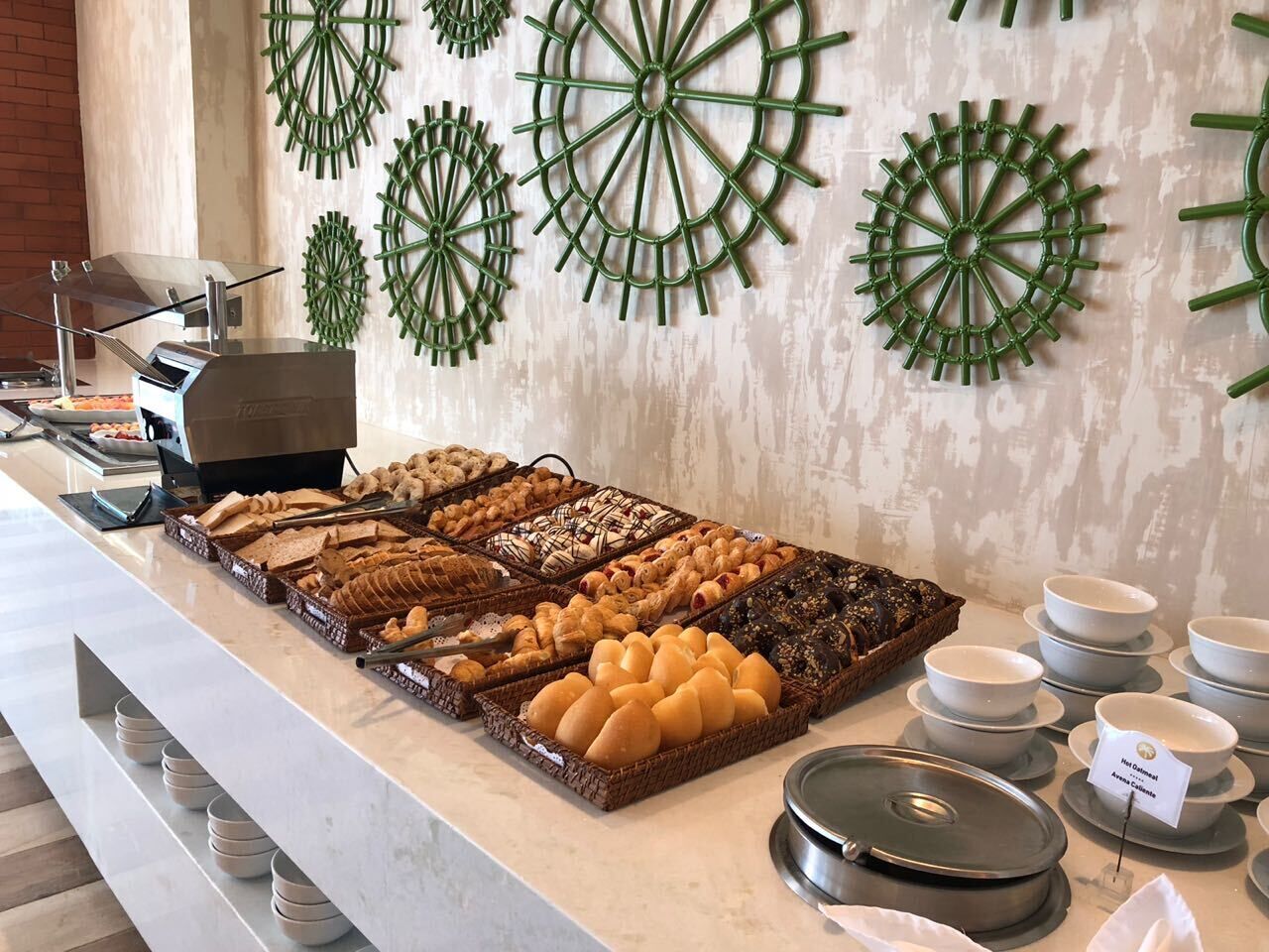 A buffet with various baked goods and a coffee station.