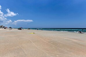 Enjoy a serene beach experience with calm seas and open spaces.