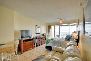 Relax in this serene bedroom with a large bed, TV, and comfortable seating area.