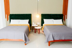 A hotel room with two beds, a small round table, and a hanging light fixture. - Acacia Hotel  (Tuxtla Gutierrez)