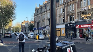A street view with a building labeled 'EDWARDS' and a 'FLIGHT CENTRE' across the street. - The Grand Bleu - Next to Tube station (London)