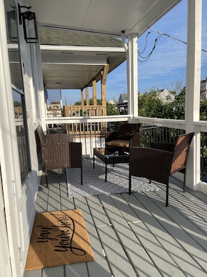 Relax in an outdoor space with a comfortable seating area and wicker furniture.