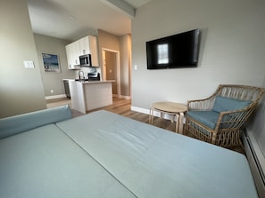 Relax in this cozy space with a large bed, kitchenette, and flat-screen TV.