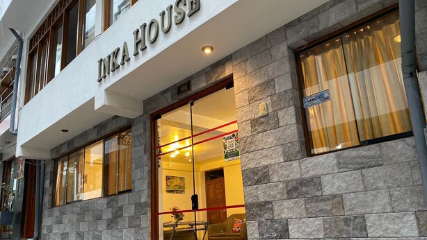 A building with a sign reading "IKEA HOUSE" and a glass door entrance. - Inka House Inn (Machu Picchu)