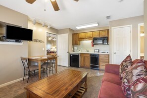 Cozy living space with a kitchenette, dining area, and comfortable seating.