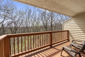 Relax on the deck with a view of the surrounding forest.