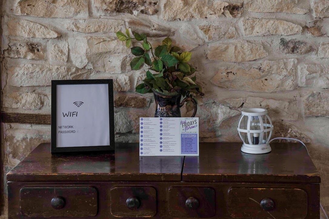 A wooden table with a framed WIFI sign, a menu, and a white lantern.