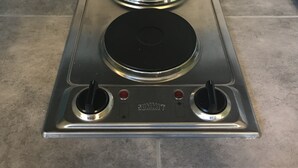 A kitchen with a stainless steel stove top with two burners and a control panel. - Cozy Efficiency Studio/A near DownTown (San Antonio)