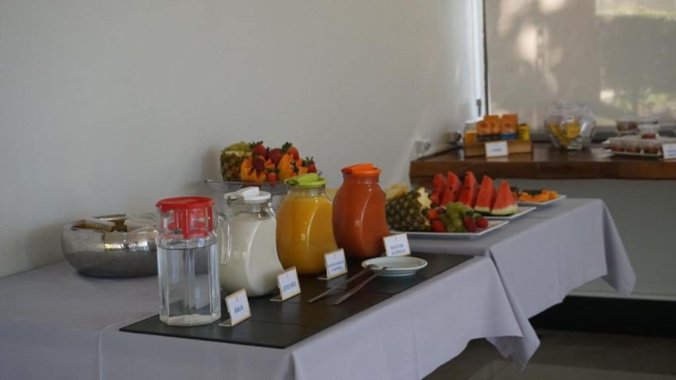 A buffet table with various food items and beverages.