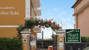 Villa Alda apartments with a sign, a gate, and a clear sky. - Holiday Apartment "Numero 7" with Sea View, 2 Balconies & Wi-Fi (Pietra Ligure)