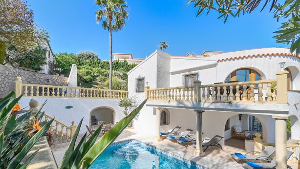 A pool area with a white building, a balcony, and lounge chairs. - Milugar - Javea, Costa Blanca (Javea)