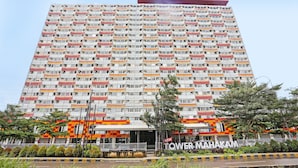 A high-rise building with multiple balconies and a sign reading "Tower Mahakam". - OYO 92317 Apartment Riverview By Alima View (Cikarang)