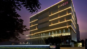 A modern building with the name "GINGER" prominently displayed on the facade. - Ginger Noida Sector 133 (Noida)