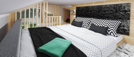 A modern bedroom with a large bed, a headboard, and a view of a balcony.