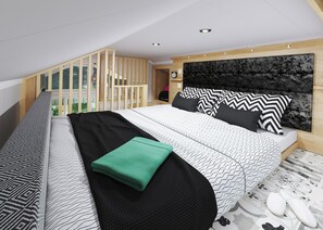 A modern bedroom with a large bed, a headboard, and a view of a balcony.