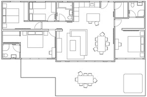 A hotel layout with multiple bedrooms, a dining area, a kitchen, and a small outdoor seating area.
