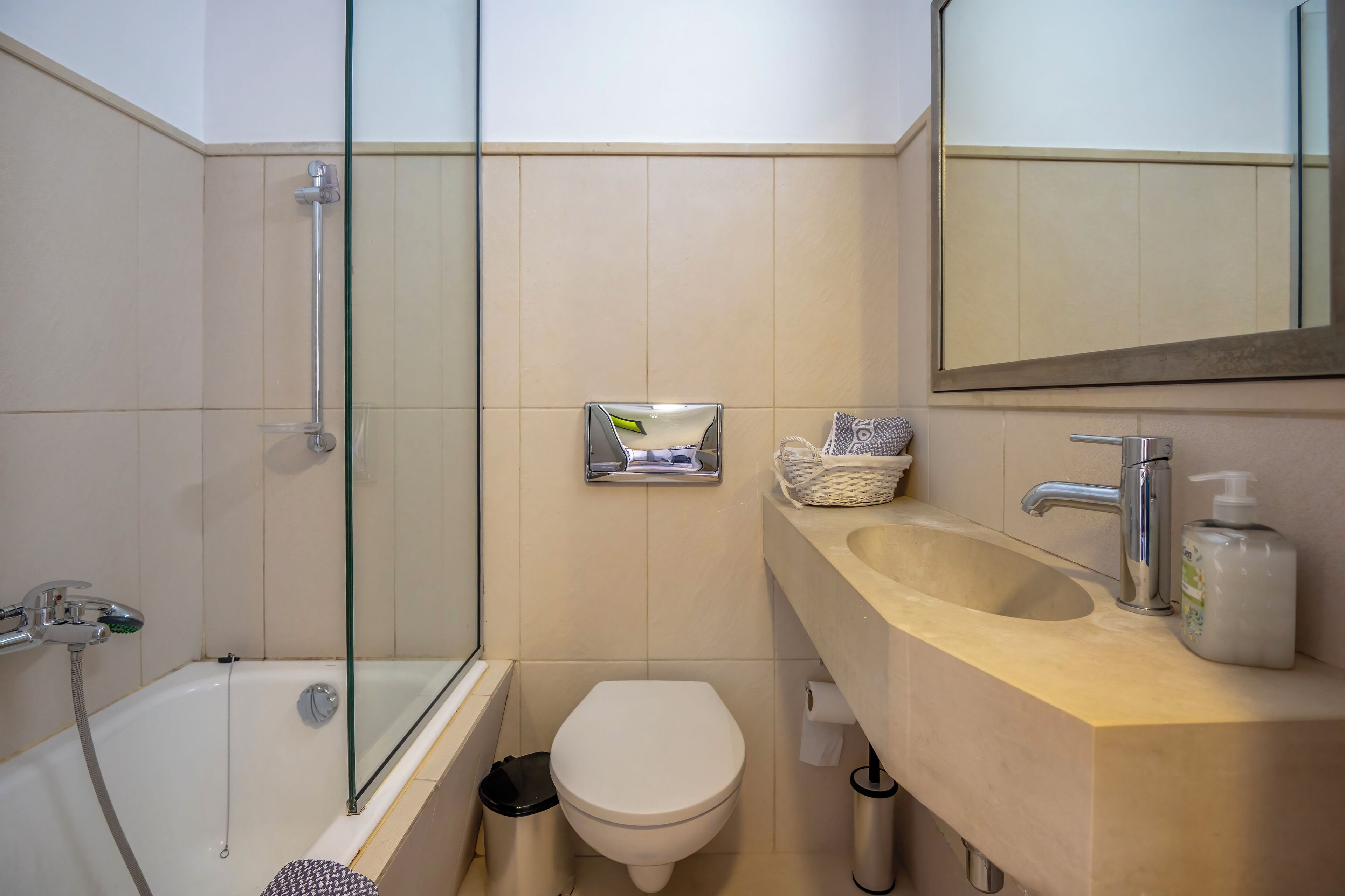 A bathroom with a bathtub, toilet, and sink.
