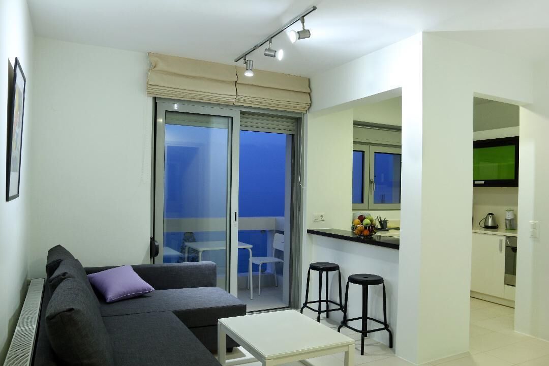 Un appartamento moderno con zona giorno, un balcone e angolo cottura.