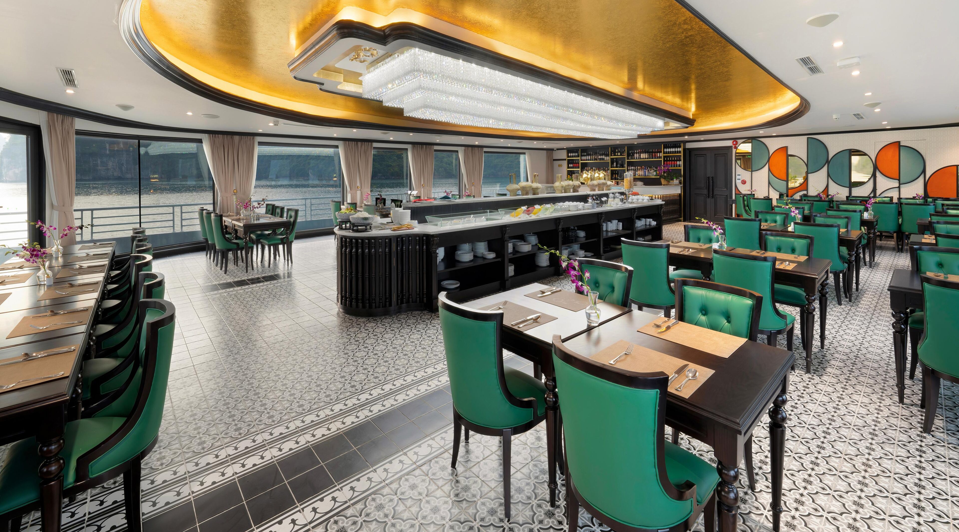 A restaurant with a bar area, green chairs, and a tiled floor.