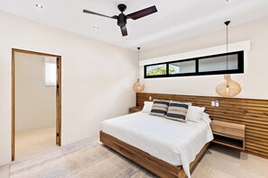 A modern bedroom with a wooden bed frame, a ceiling fan, a bedside table, and a wall-mounted shelf.