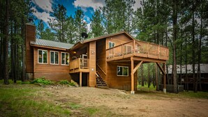A wooden cabin with a deck, a chimney, and a staircase leading to a second level. - Pet-friendly cabin in the pines, 2 decks w/grill, <10 to skiing (Angel Fire)