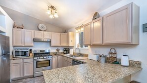 A kitchen with granite countertops, stainless steel appliances, and light wood cabinets. - Pet-friendly cabin in the pines, 2 decks w/grill, <10 to skiing (Angel Fire)
