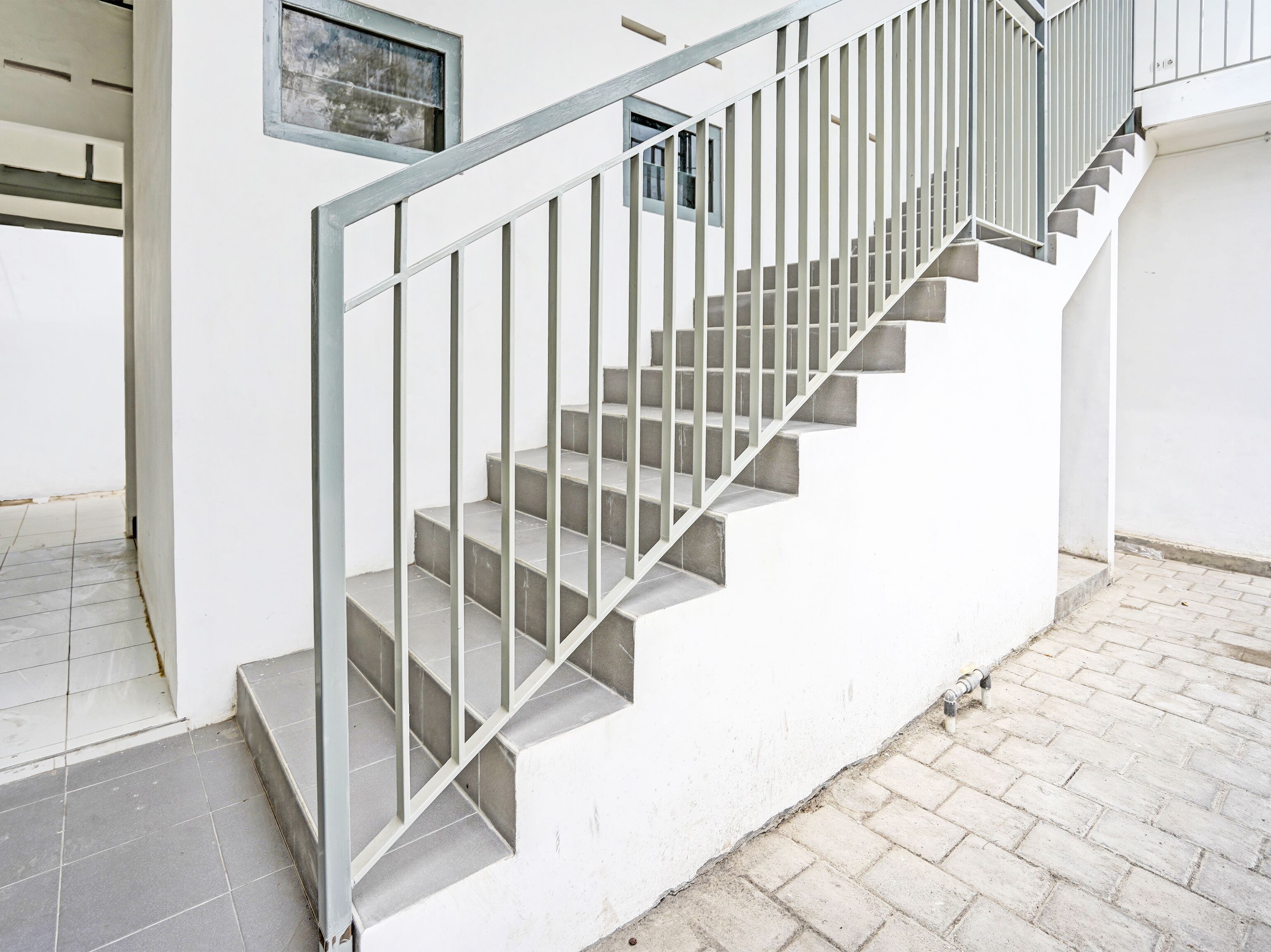 A staircase with metal railings leading to an upper floor.
