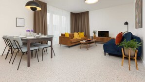 A modern living room with a dining area, a sofa, and a coffee table.
