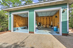 A two-car garage with wooden walls and a green exterior.