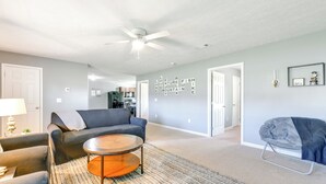 A living room with a gray sofa, a round coffee table, and a ceiling fan. - 2 Mi to Douglas Lake, Boat Ramp: White Pine Home! (White Pine)