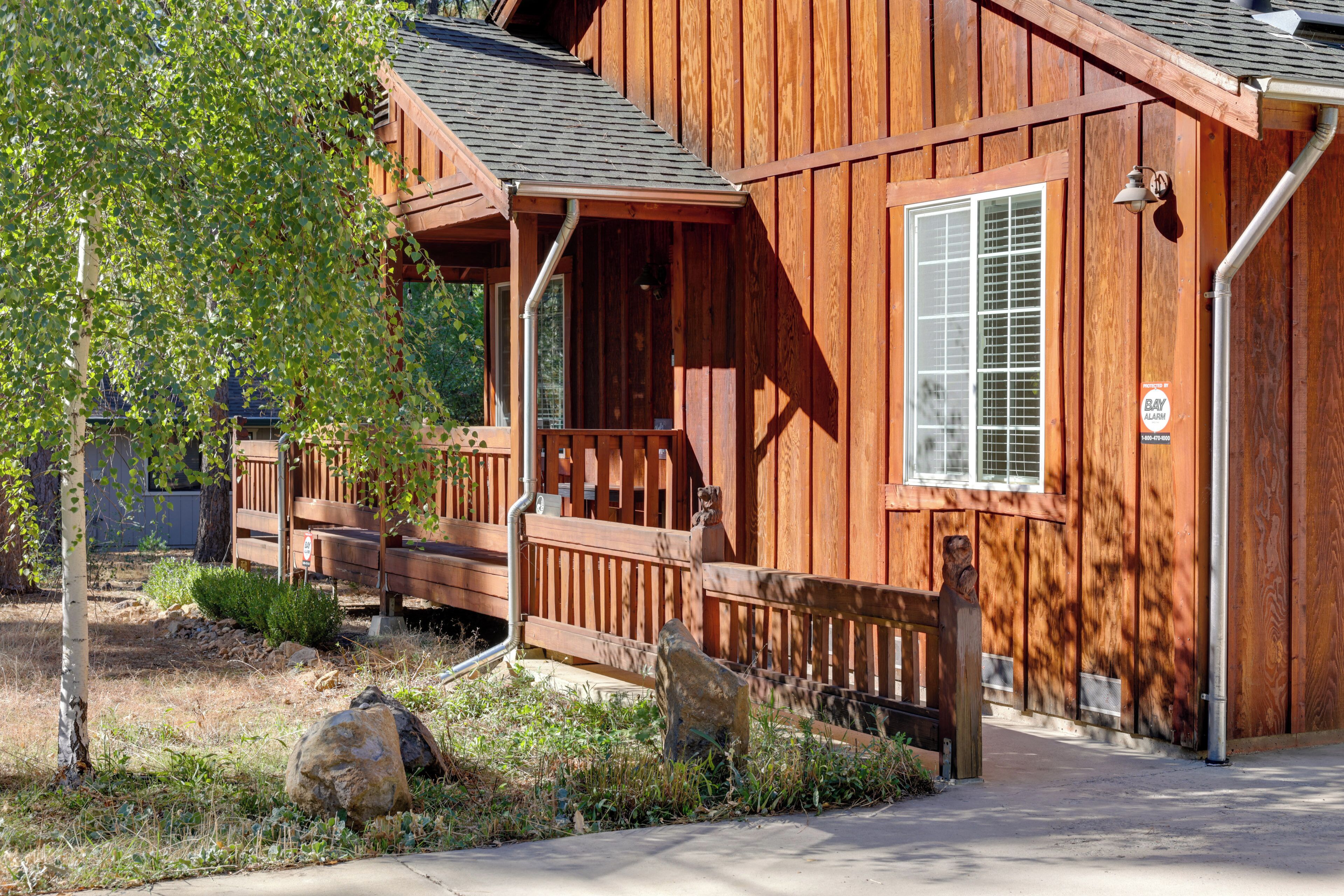A wooden building with a porch, a window, and a visible door.