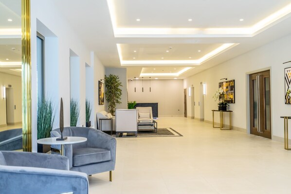Relax in the stylish seating area with a sofa, armchair, and potted plant.