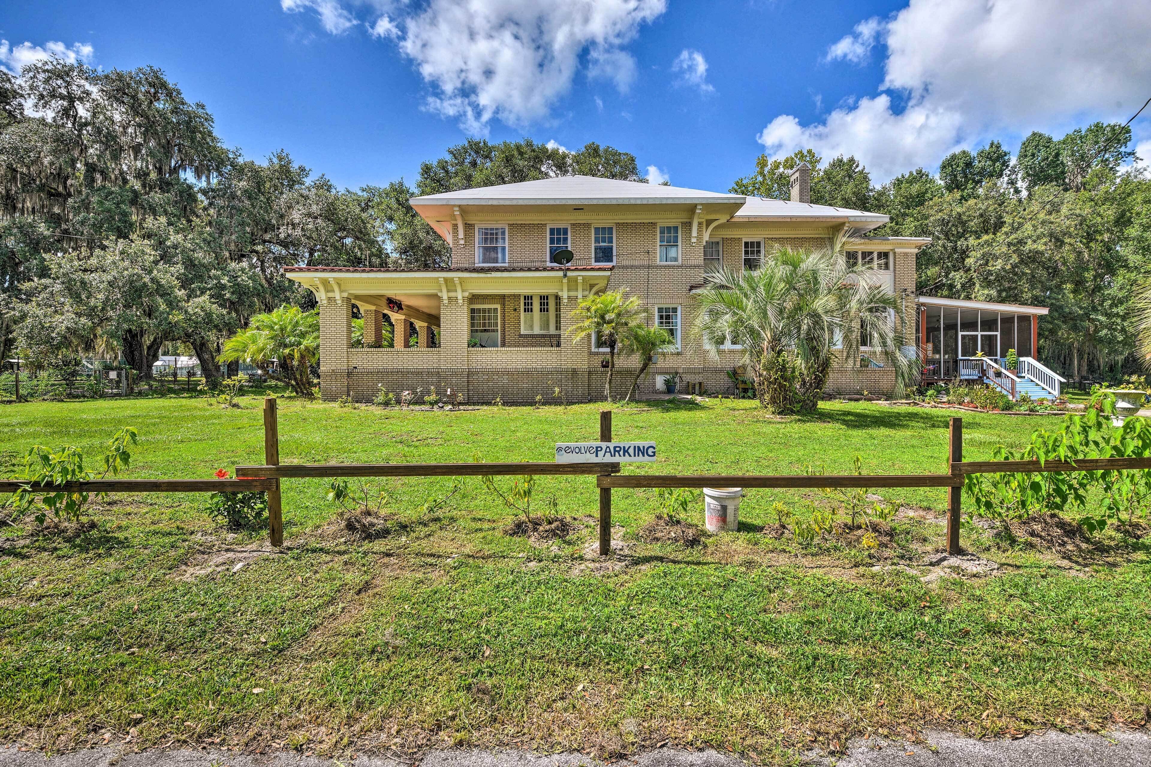 A two-story house with a porch and a fenced yard.