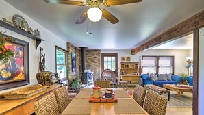 A spacious dining area with a wooden table, woven chairs, and a ceiling fan. - Cabin in Beautiful Setting Between Ouray & Ridgway (Ridgway)