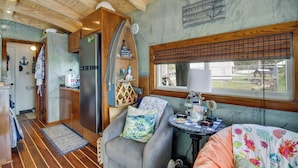 A compact kitchen with a refrigerator, wooden cabinets, and a window with blinds. - Bay St Louis Houseboat 6 Mi to Old Town & Beach! (Bay St Louis)
