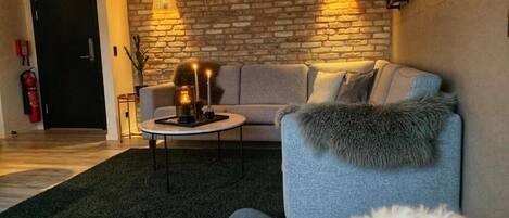 Relax in this stylish living room with a grey sofa, coffee table, and framed artwork.