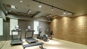 A gym with treadmills, elliptical machines, and a bench. - Tosei Hotel COCONE Tsukiji Ginza Premier (Tokyo)