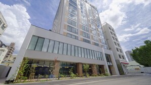 A modern multi-story building with large windows and a flat roof. - Tosei Hotel COCONE Tsukiji Ginza Premier (Tokyo)