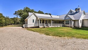 A large, single-story house with a covered porch and a gravel driveway. - 12 Mi to Tcu: Fort Worth Cottage w/ Farmland Views (Fort Worth)