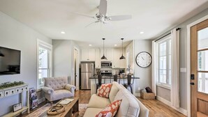 A modern living room with a sofa, coffee table, and a TV. - 12 Mi to Tcu: Fort Worth Cottage w/ Farmland Views (Fort Worth)