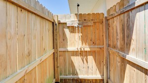 A wooden fence with a metal gate and a security camera mounted on the top. - Dog-friendly Home w/ Patio & BBQ in Bradenton (Bradenton)