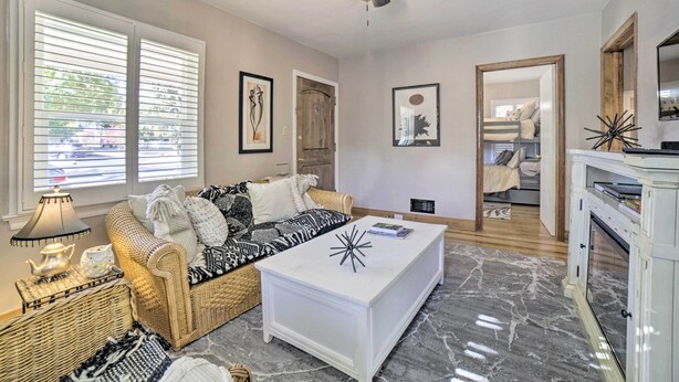 A living room with a sofa, coffee table, and a ceiling fan. - Hot Tub + Walk to Midtown! Reno Retreat (Reno)