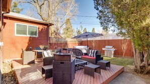 A deck with wicker furniture, a grill, and a potted plant. - Hot Tub + Walk to Midtown! Reno Retreat (Reno)