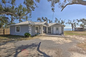 A two-story house with a covered porch, a small front yard, and a view of the water. - Bayfront Panama City Studio Near Tyndall Afb! (Panama City)