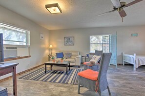 A living room with a sofa, armchairs, a coffee table, and a ceiling fan. - Bayfront Panama City Studio Near Tyndall Afb! (Panama City)