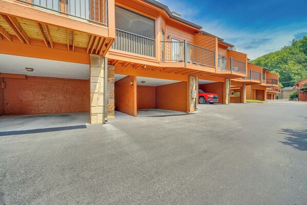A multi-story building with balconies and a red car parked in the driveway. - Walkable Dtwn Gatlinburg Townhome w/ Pool Access! (Gatlinburg)